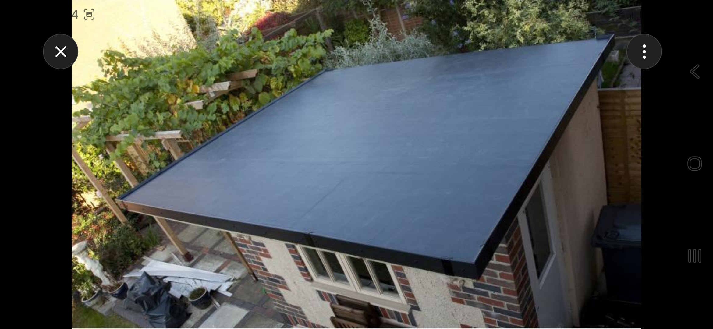 Close view of a completed black EPDM rubber membrane flat roof